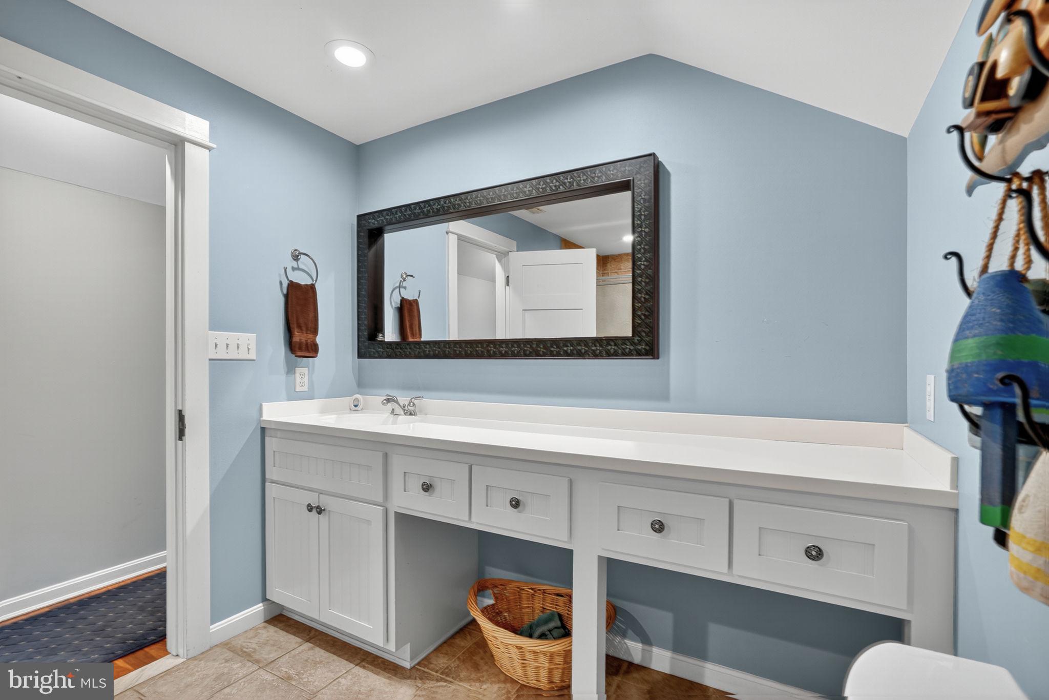 501 South Main Street Berlin, MD 21811 - Photo 45 of 75 a bathroom with a toilet sink and mirror