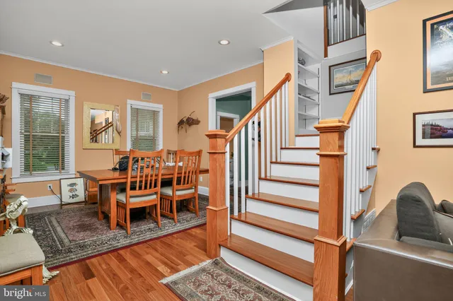 a living room with furniture kitchen view and large windows