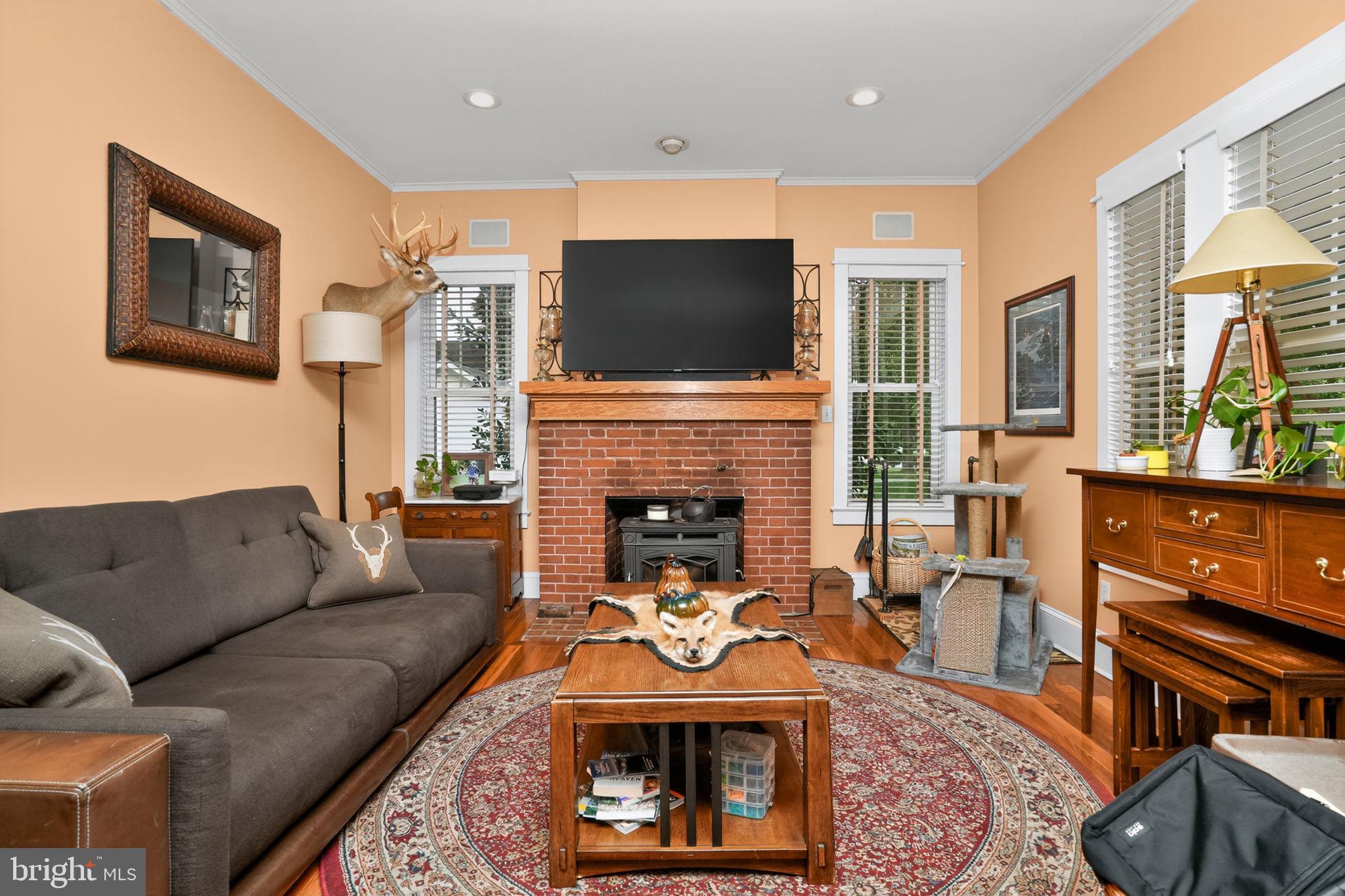 501 South Main Street Berlin, MD 21811 - Photo 8 of 75 a living room with furniture a flat screen tv and a fireplace