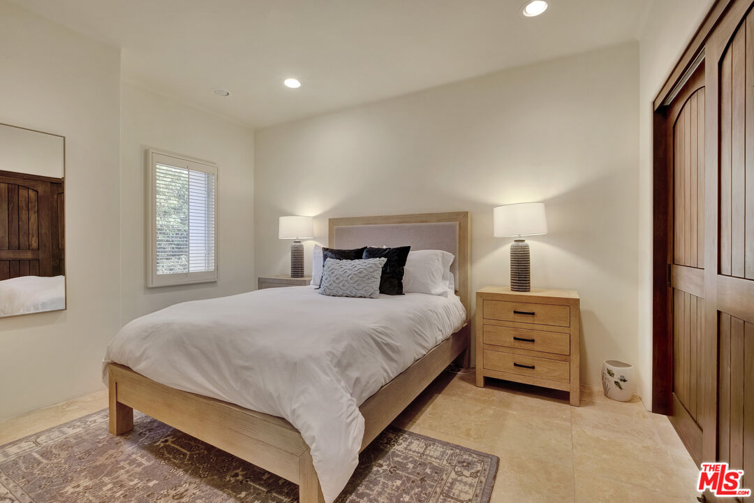 211 Bath Street Santa Barbara, CA 93101 - Photo 11 of 25 a bedroom with a bed and window