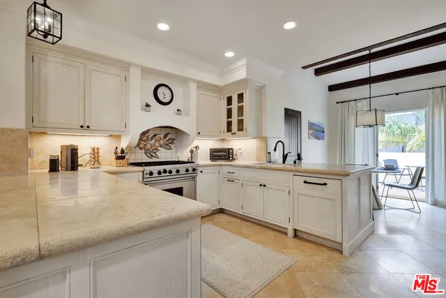 a kitchen with cabinets appliances and a counter top space