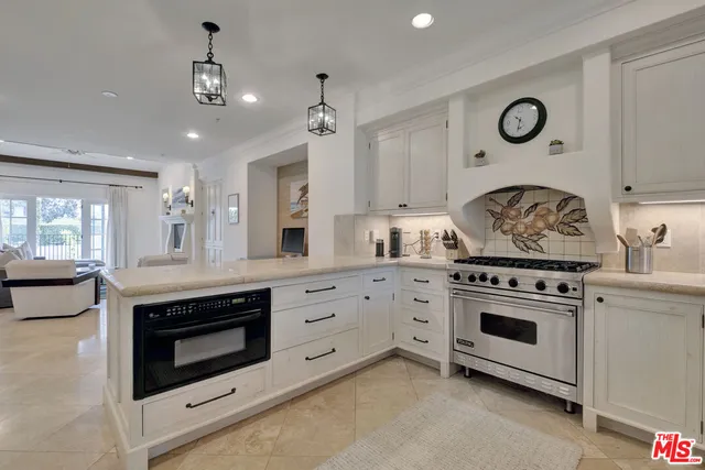 a kitchen with granite countertop a stove oven and a sink