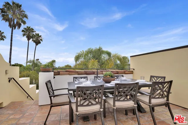 a view of an outdoor space with furniture and garden