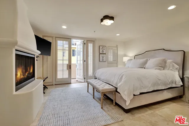 a spacious bedroom with a bed and a large window