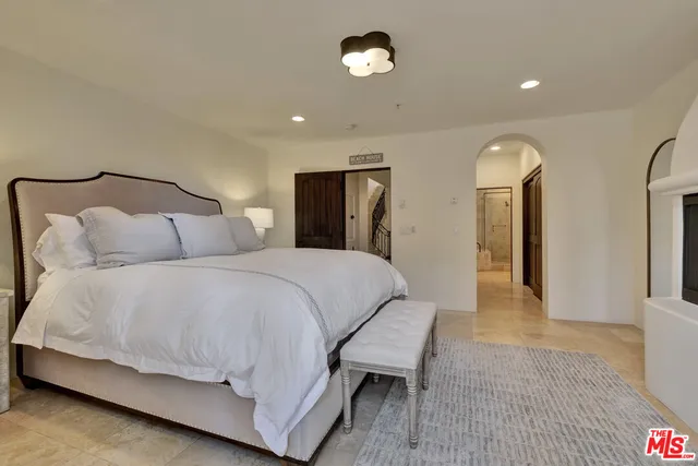 a bedroom with a bed and a chandelier