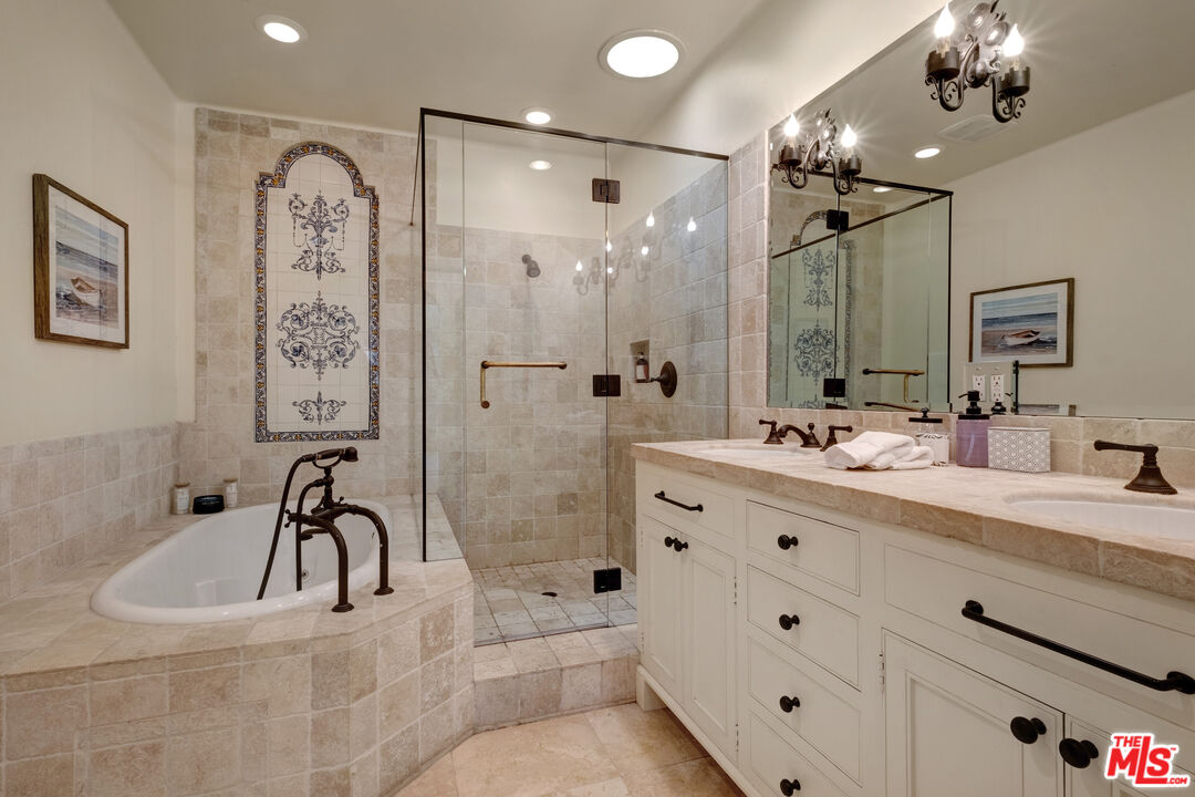 211 Bath Street Santa Barbara, CA 93101 - Photo 8 of 25 a bathroom with a bathtub sink double vanity and mirrors
