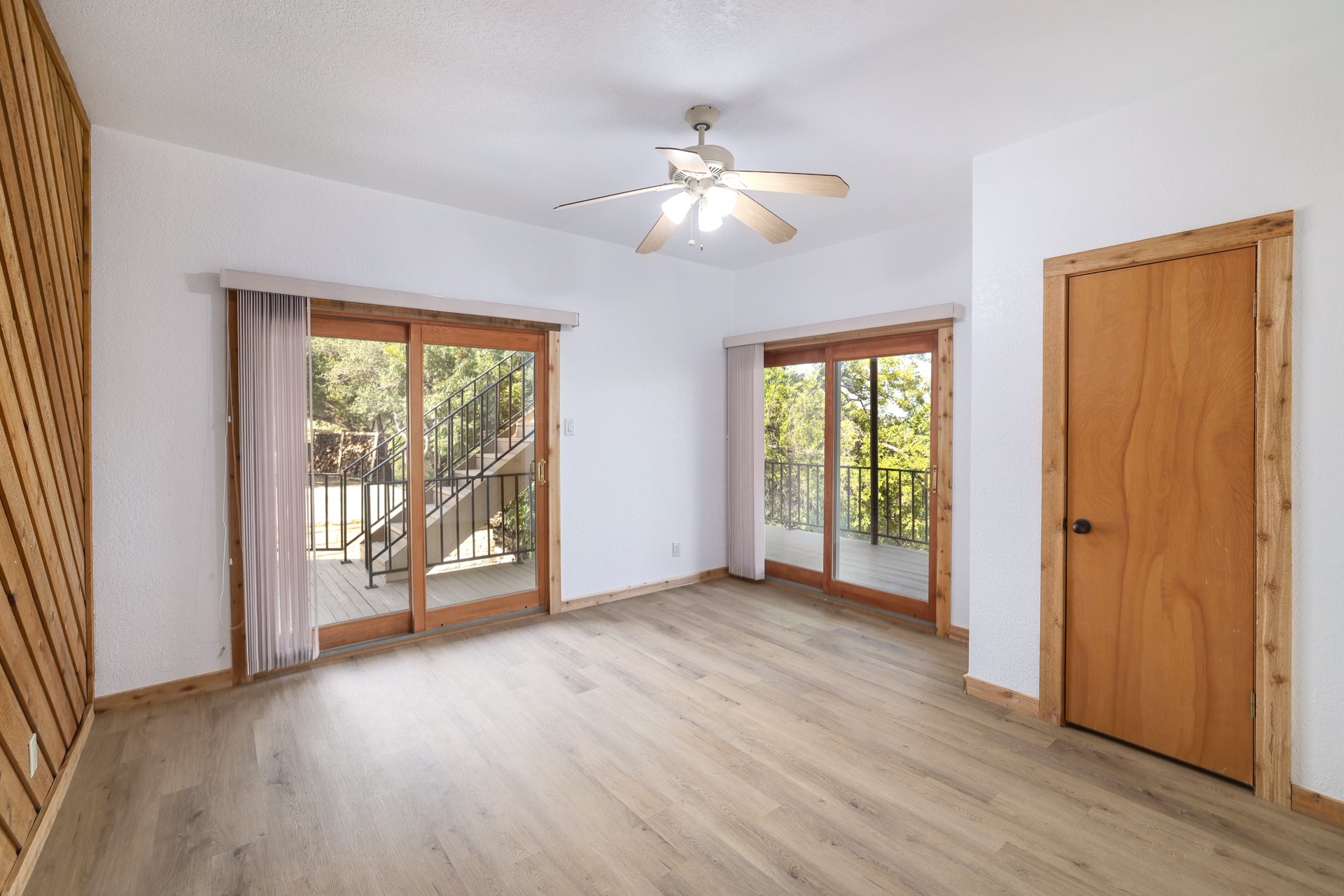 313 Kendall Road Spicewood, TX 78669 - Photo 15 of 34 Empty room with light wood-type flooring and a ceiling fan