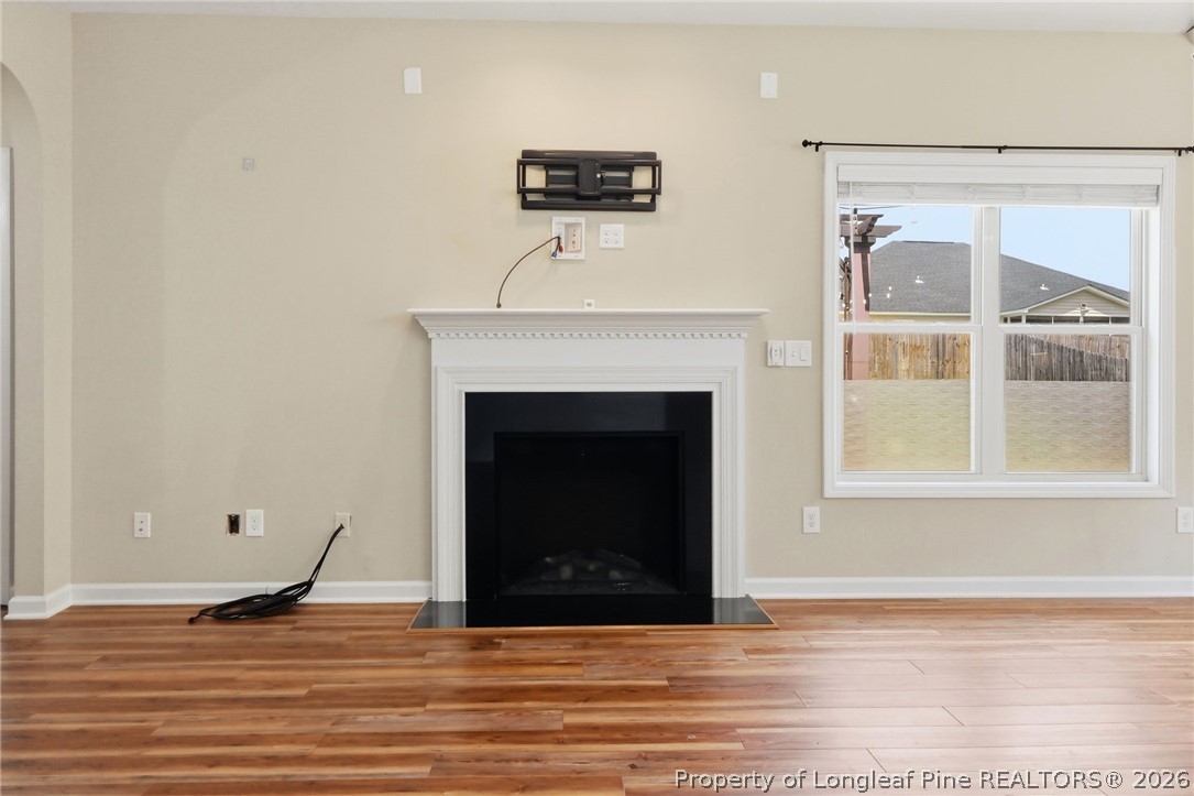 33 Colonist Place Cameron, NC 28326 - Photo 11 of 47 a view of an empty room with wooden floor and a fireplace