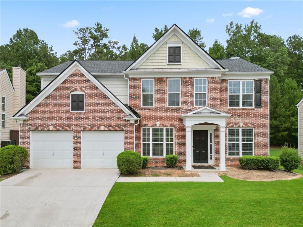 a front view of a house with a yard