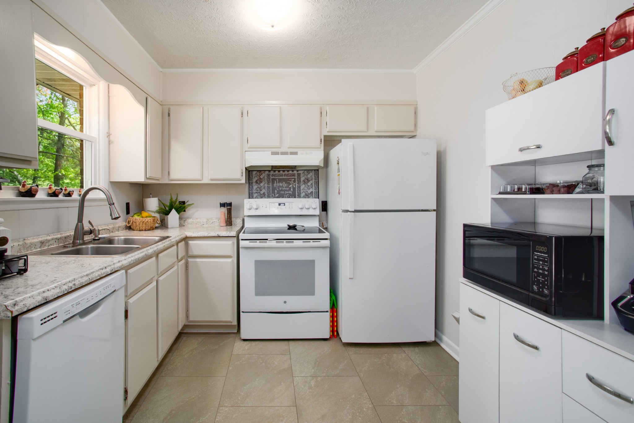 7711 Chester Road Fairview, TN 37062 - Photo 12 of 21 a kitchen with stainless steel appliances a refrigerator sink and cabinets