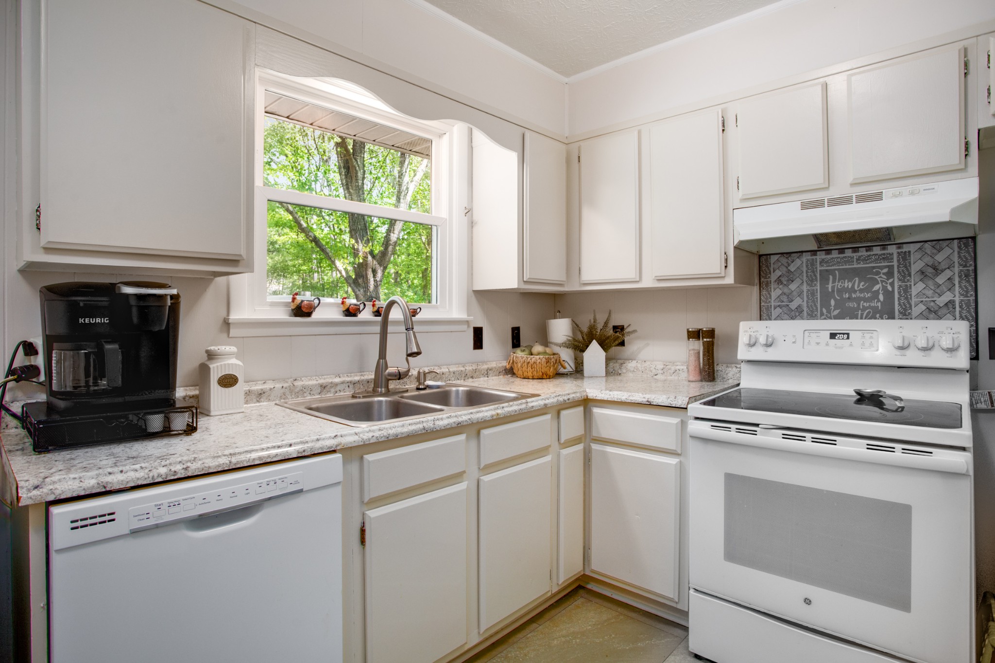 7711 Chester Road Fairview, TN 37062 - Photo 13 of 21 a kitchen with white cabinets and white appliances