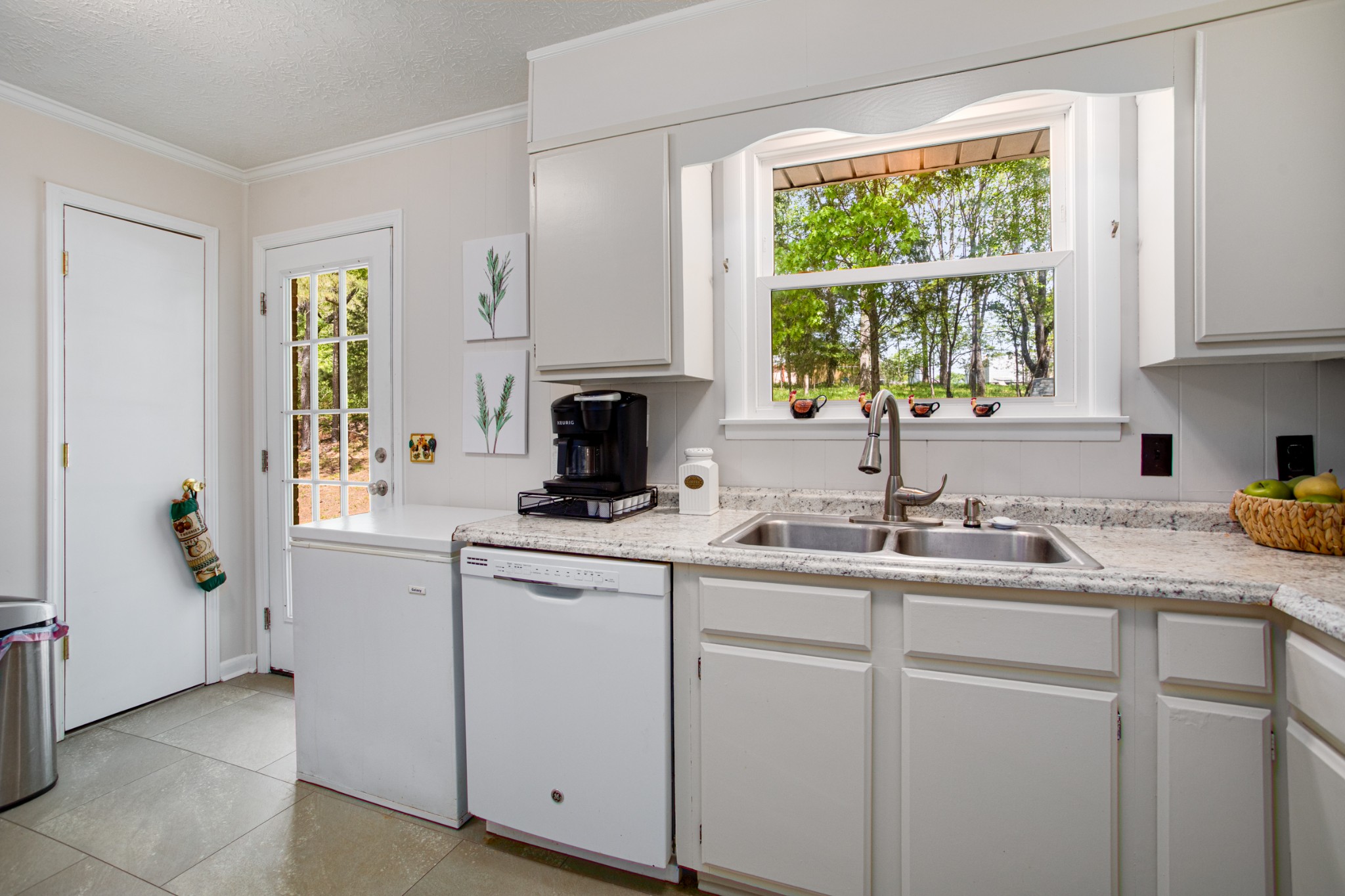 7711 Chester Road Fairview, TN 37062 - Photo 14 of 21 a kitchen with white cabinets and a window