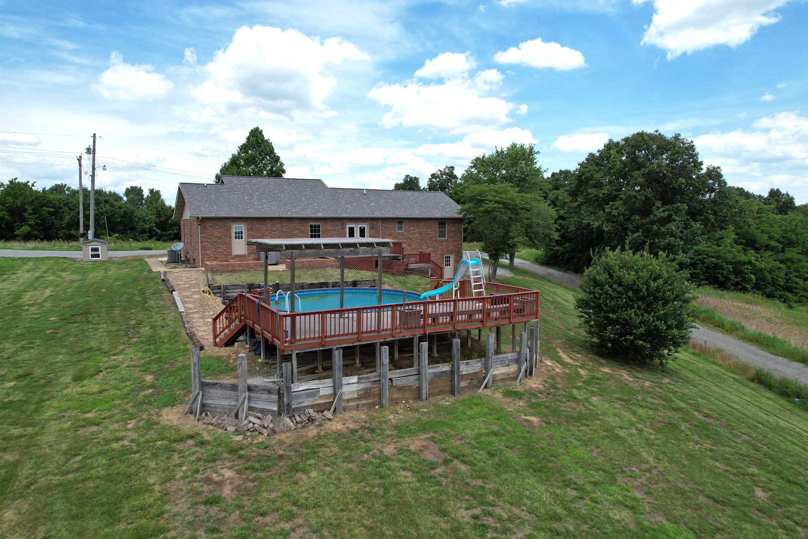 5488 Tick Ridge Road Grand Chain, IL 62941 - Photo 12 of 55 a view of a house with a wooden deck and a big yard