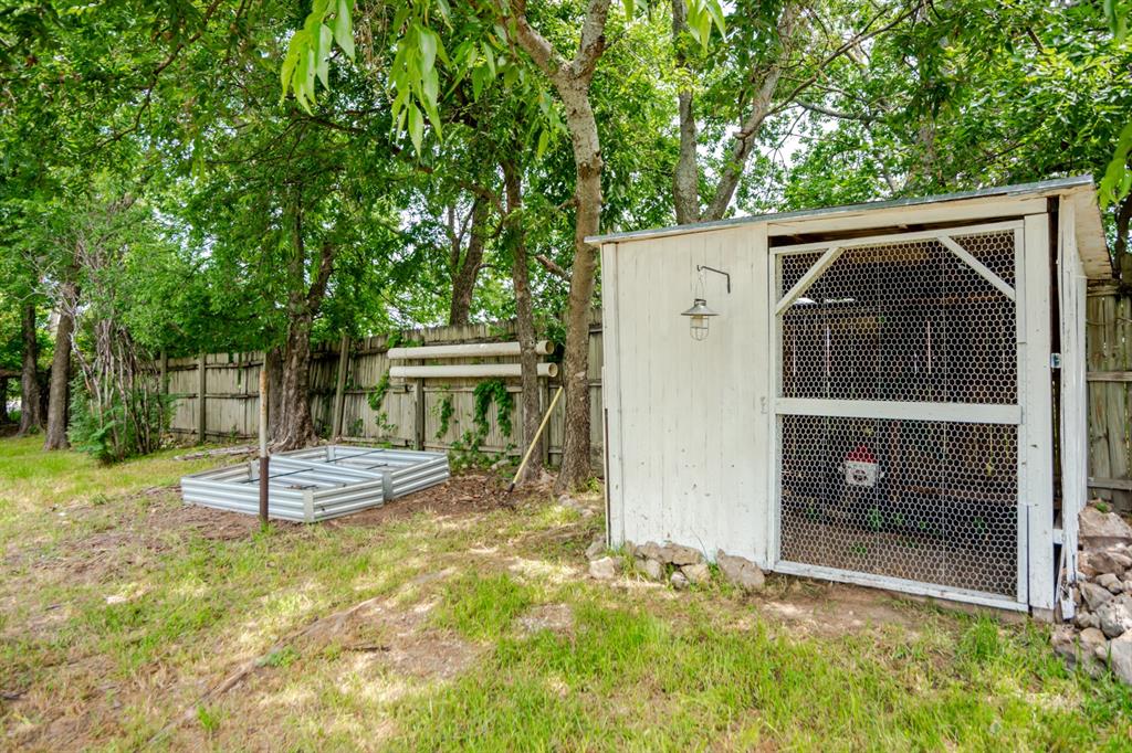 199 B.C. Rhome Avenue Rhome, TX 76078 - Photo 11 of 34 a view of a wooden house with a yard and large tree