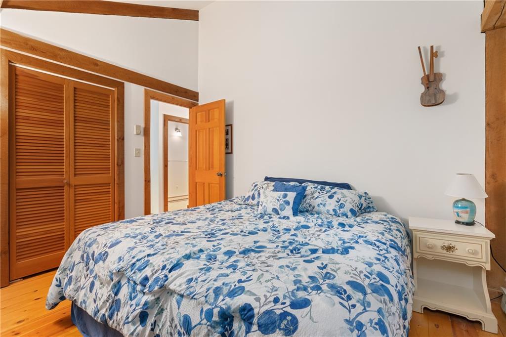 271 Snowshoe Road Acme, PA 15610 - Photo 18 of 37 a bedroom with a bed and wooden floor