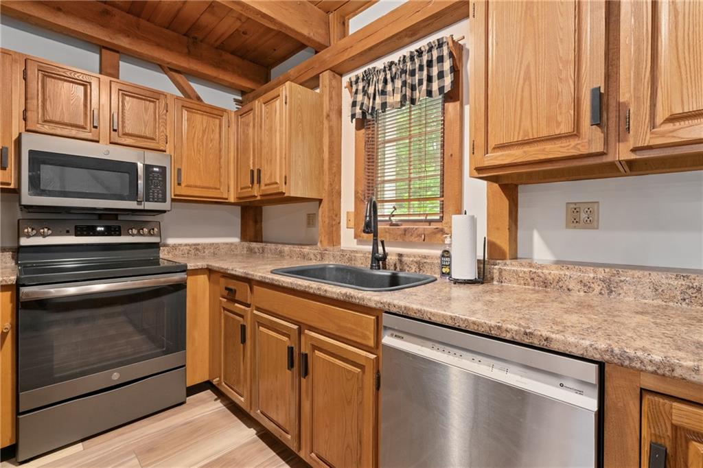 271 Snowshoe Road Acme, PA 15610 - Photo 8 of 37 a kitchen with stainless steel appliances granite countertop a stove a sink and a microwave