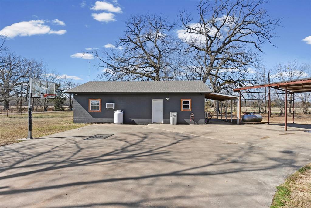 24 County Rd NW 1060 Talco, TX 75487 - Photo 34 of 40 a front view of a house with a yard and garage