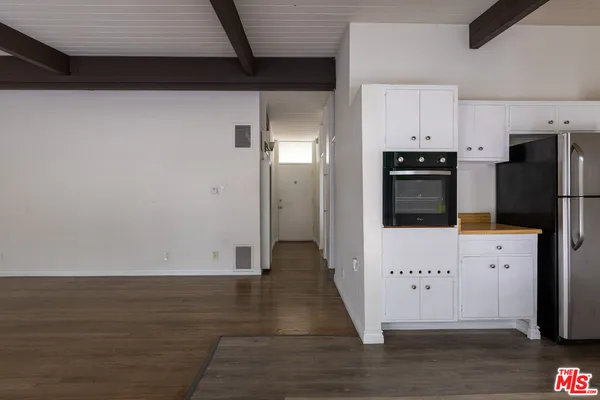a view of a kitchen with wooden floor