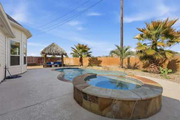 an empty room with fan and windows