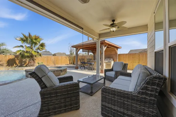 a bathroom with a granite countertop sink a toilet and bathtub