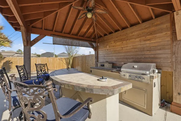 a spacious bathroom with a granite countertop sink a mirror and a bathtub
