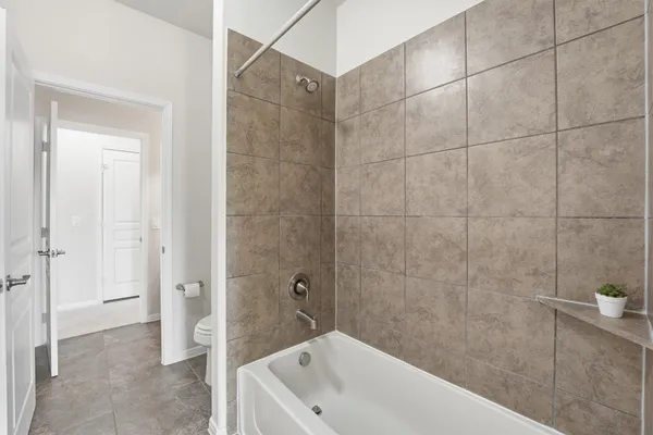 a front view of a house with a garden and plants