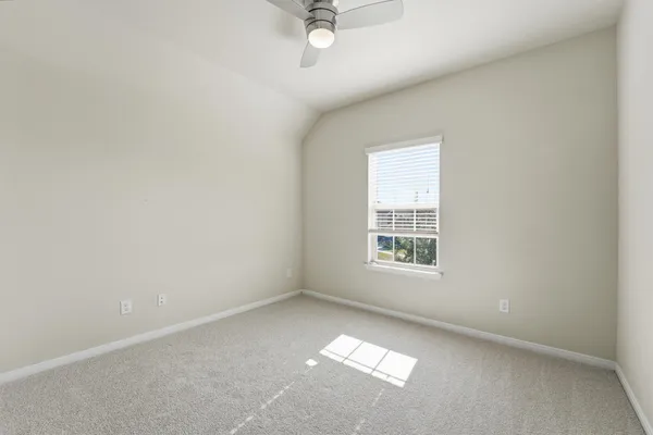 a front view of a house with a garden and yard
