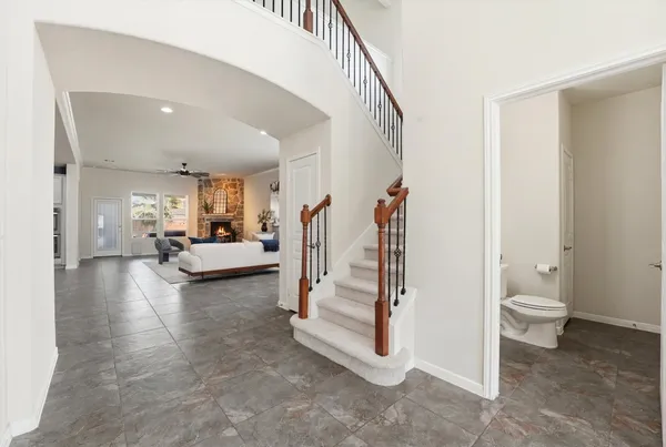 a kitchen with a sink a stove a refrigerator and white cabinets with wooden floor