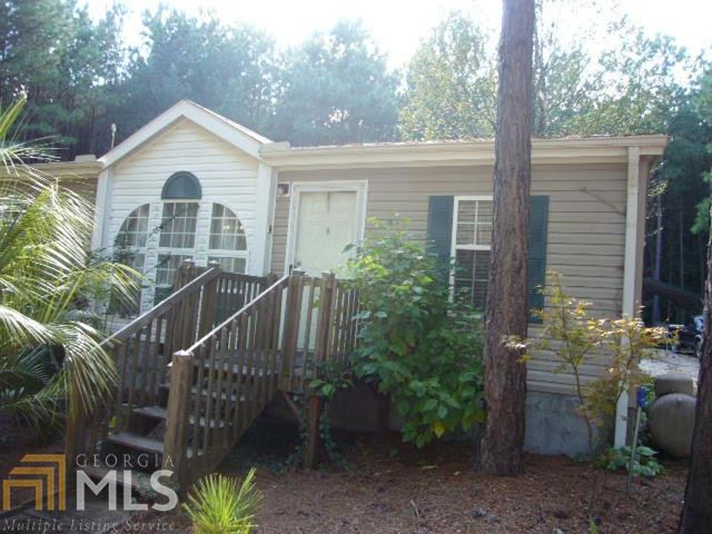 a front view of a house with yard and green space