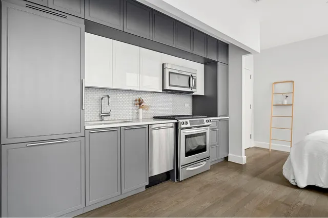 a kitchen with cabinets and stainless steel appliances