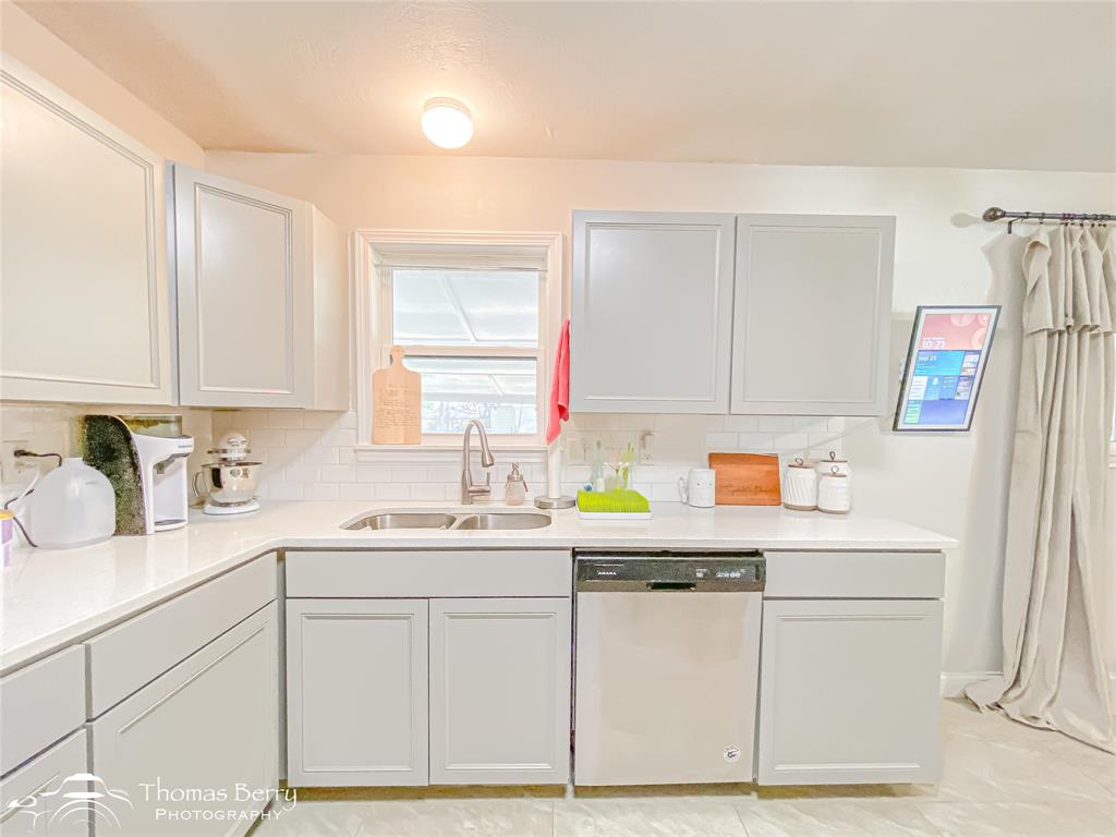 1502 Sunset Street Merkel, TX 79536 - Photo 11 of 35 a kitchen with granite countertop a sink cabinets and window
