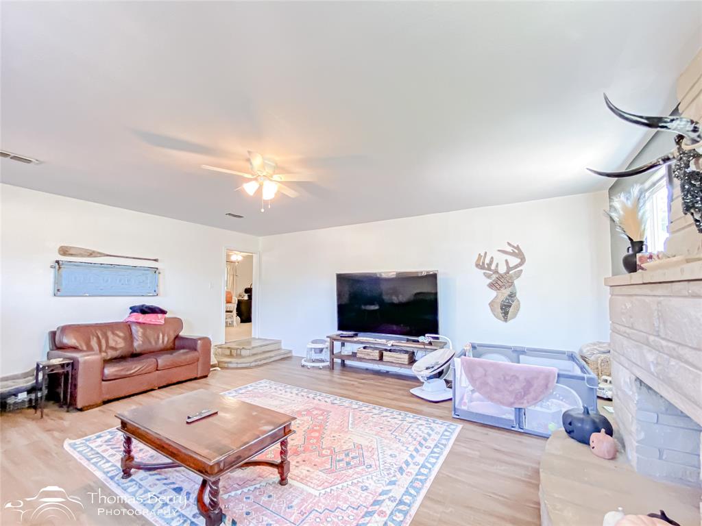 1502 Sunset Street Merkel, TX 79536 - Photo 16 of 35 a living room with furniture and a flat screen tv