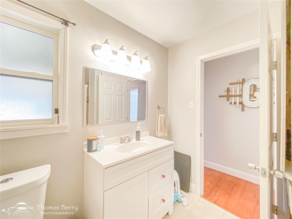 1502 Sunset Street Merkel, TX 79536 - Photo 24 of 35 a bathroom with a sink vanity and mirror