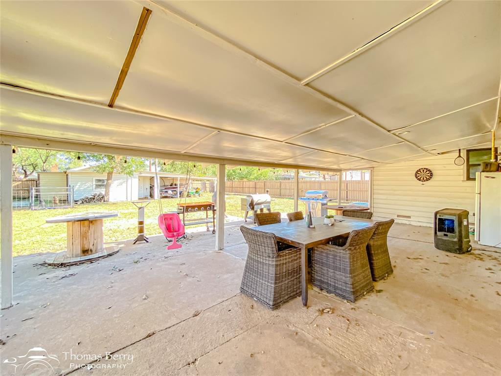 1502 Sunset Street Merkel, TX 79536 - Photo 30 of 35 a view of a swimming pool with a table and chairs