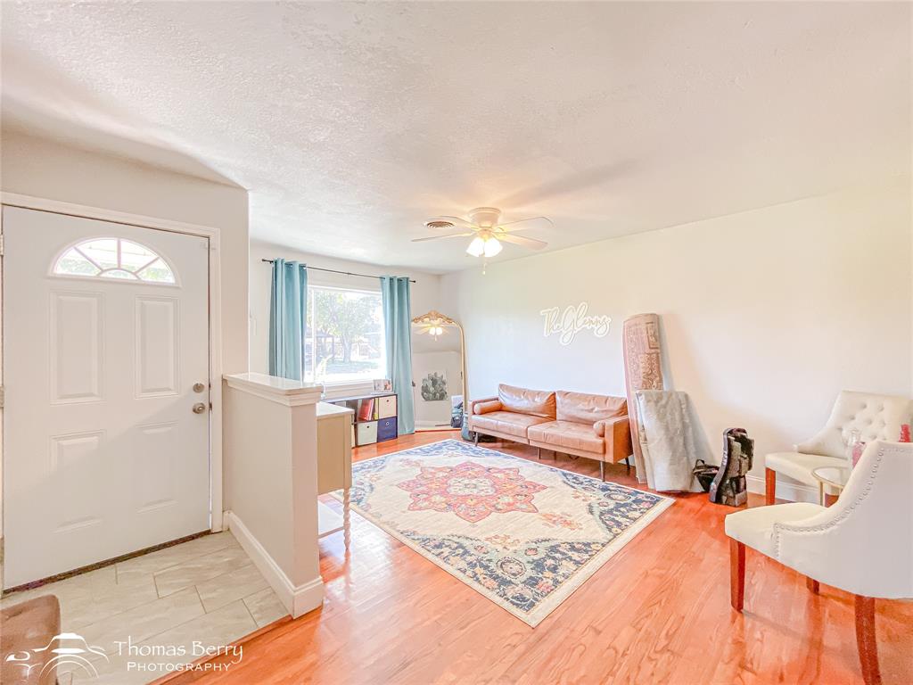 1502 Sunset Street Merkel, TX 79536 - Photo 8 of 35 a bedroom with furniture and a wooden floor