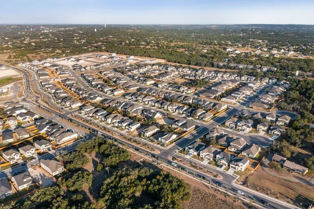 an aerial view of residential building and ocean view
