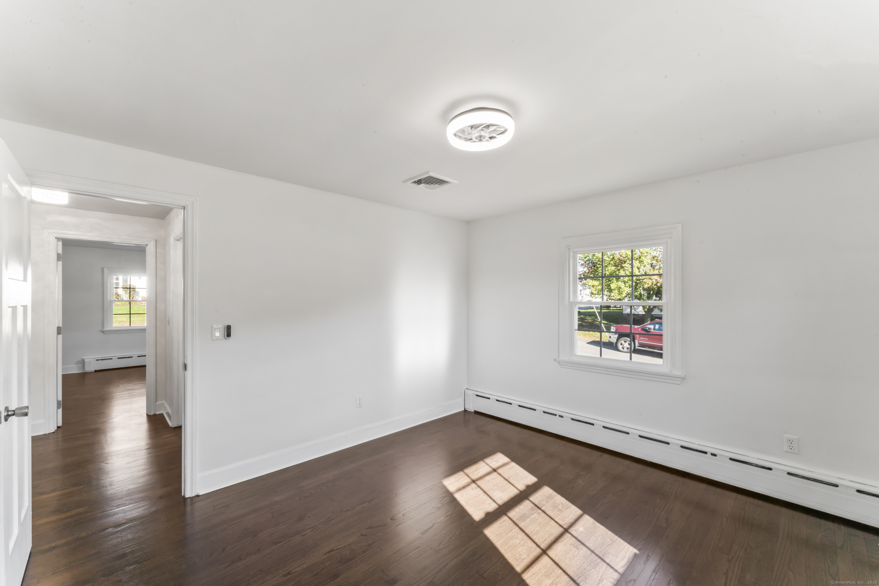92 Feldspar Avenue Beacon Falls, CT 06403 - Photo 18 of 32 an empty room with wooden floor and windows