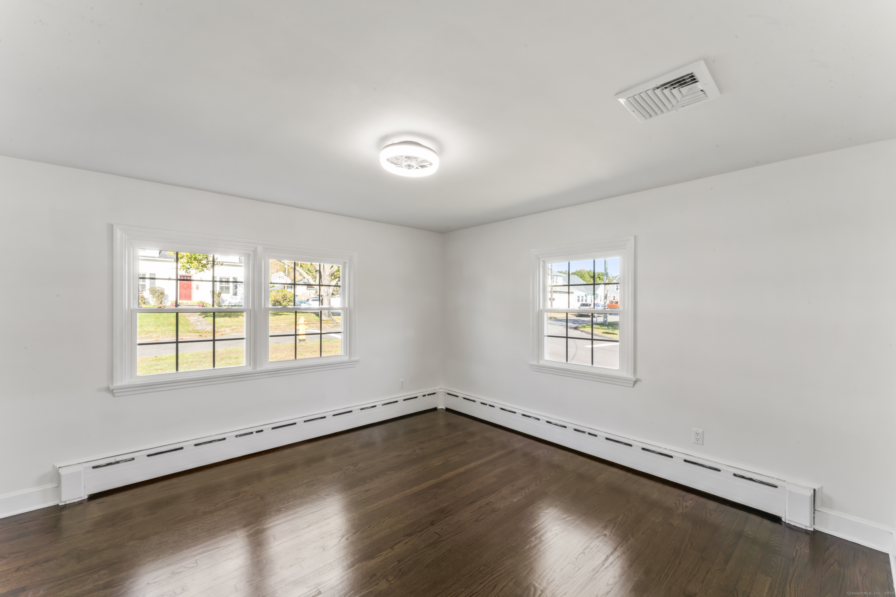 92 Feldspar Avenue Beacon Falls, CT 06403 - Photo 21 of 32 an empty room with wooden floor and windows
