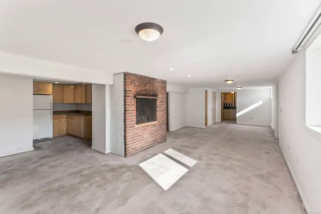 a view of kitchen with furniture and a refrigerator