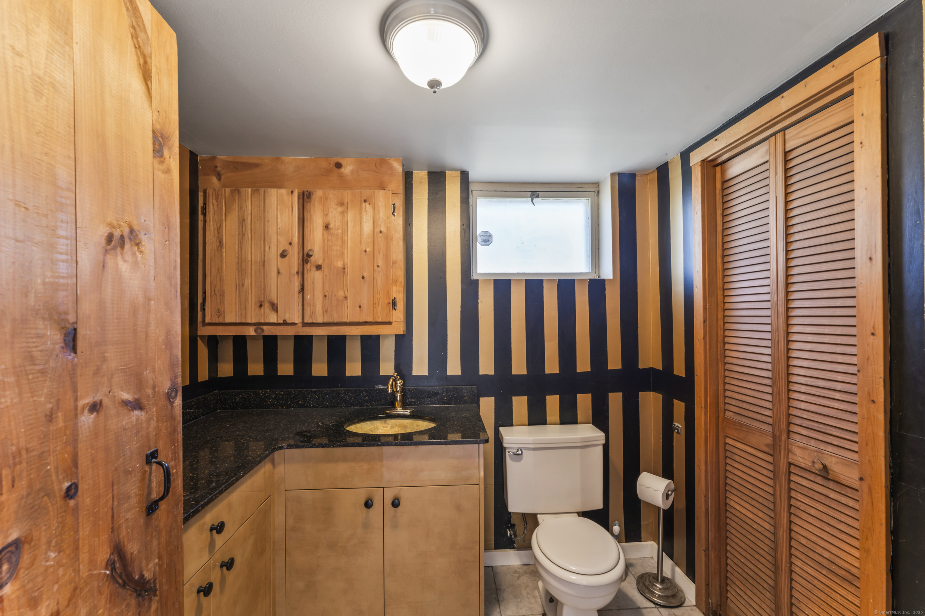 92 Feldspar Avenue Beacon Falls, CT 06403 - Photo 27 of 32 a bathroom with a toilet a sink and a mirror
