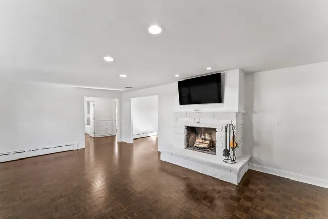 a living room with a fireplace and a flat screen tv