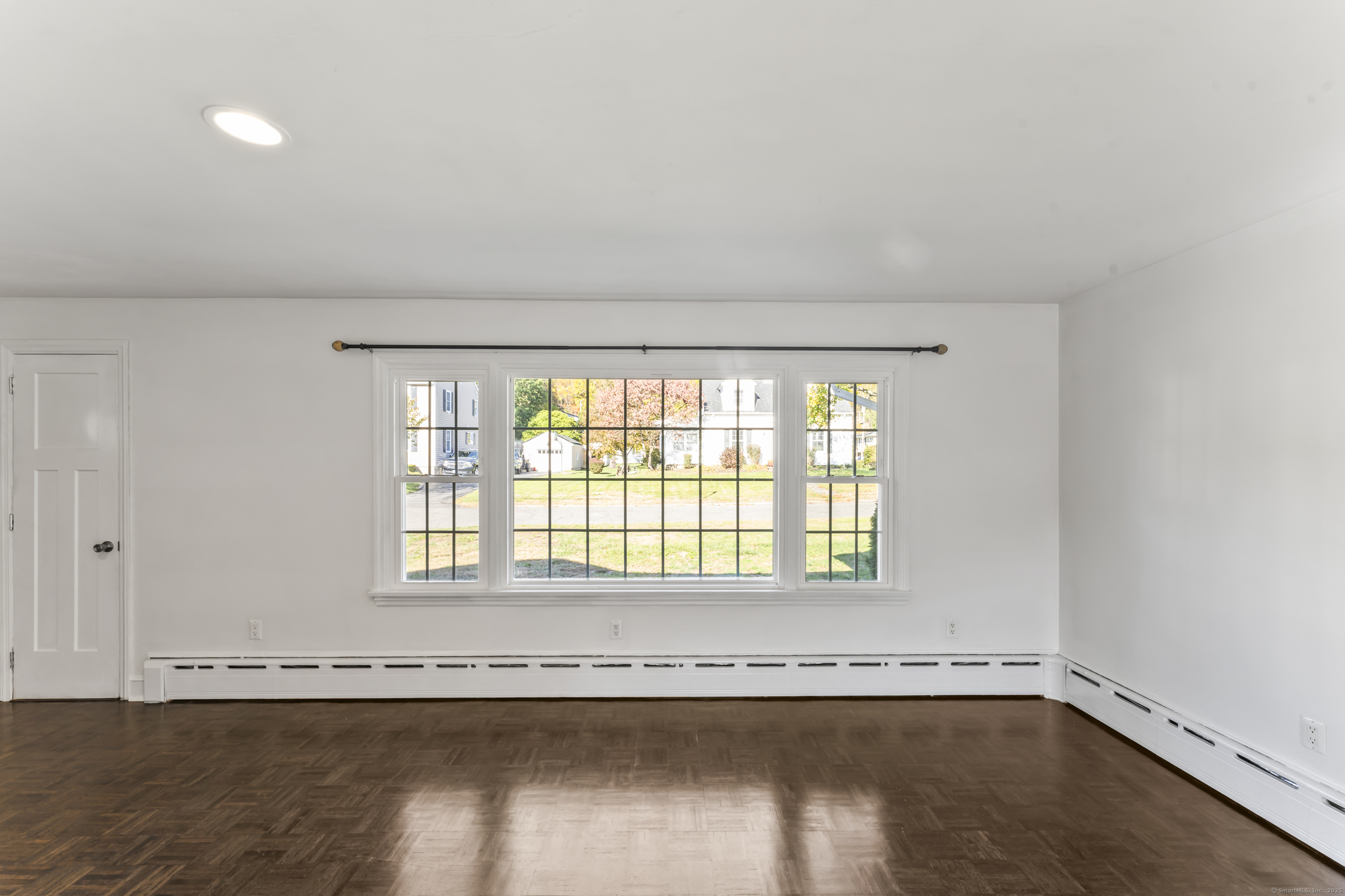 92 Feldspar Avenue Beacon Falls, CT 06403 - Photo 6 of 32 a view of an empty room with wooden floor and a window
