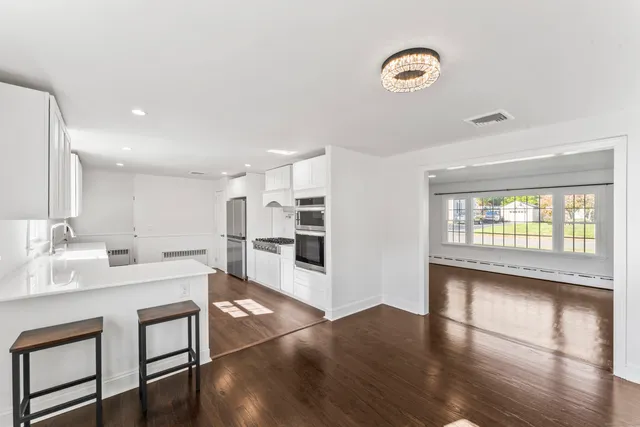 a large white kitchen with a window