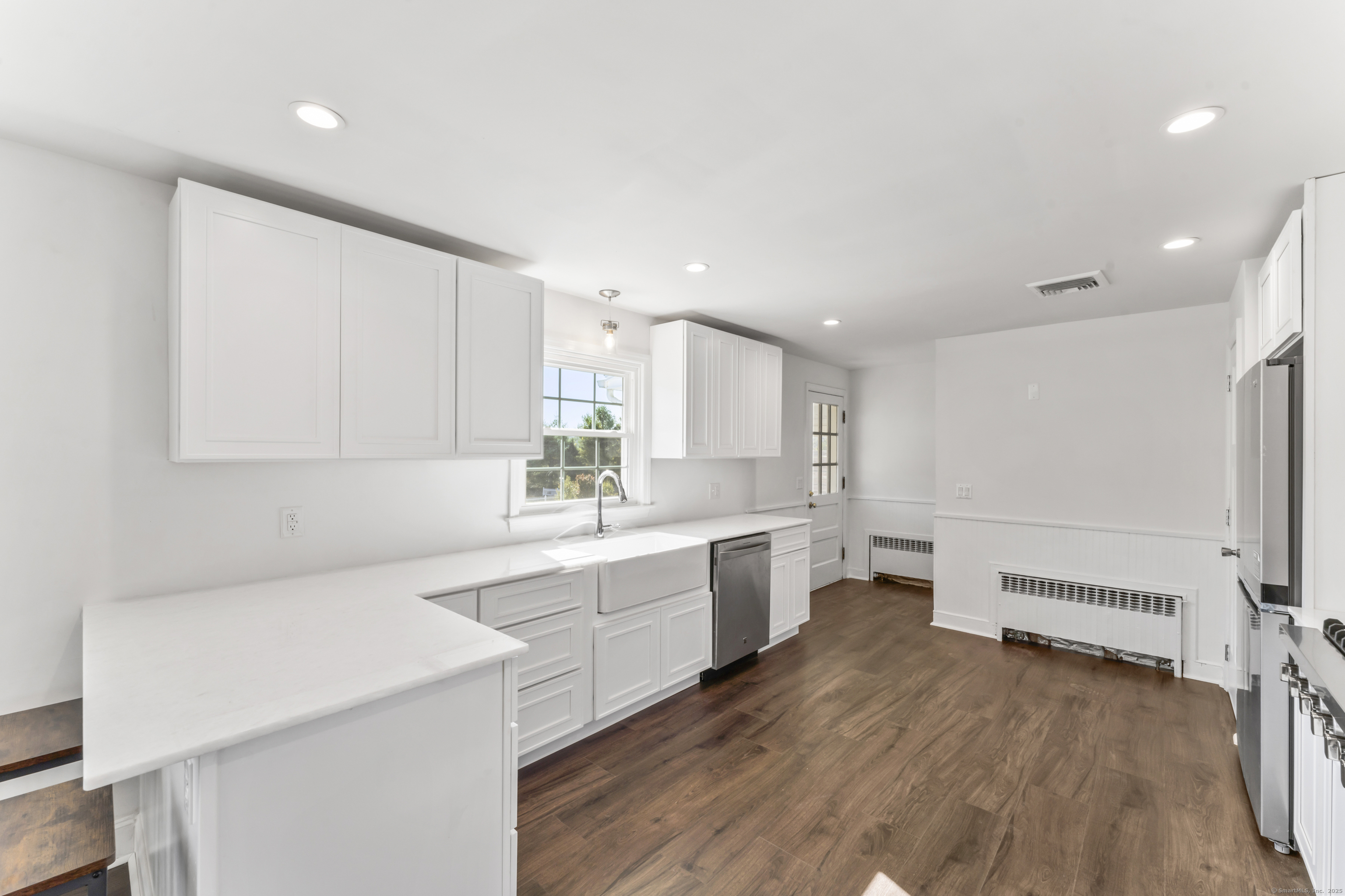 92 Feldspar Avenue Beacon Falls, CT 06403 - Photo 10 of 32 a large white kitchen with wooden floor and a sink
