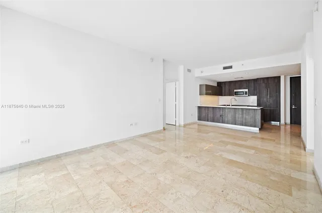a kitchen with stainless steel appliances a sink stove and cabinets