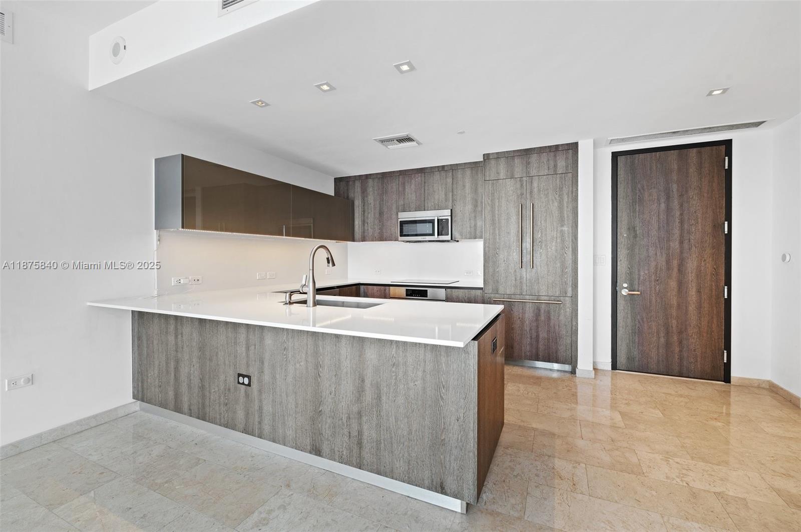 88 Southwest 7th Street, Unit 1403 Miami, FL 33130 - Photo 15 of 53 a kitchen with stainless steel appliances a sink stove and cabinets