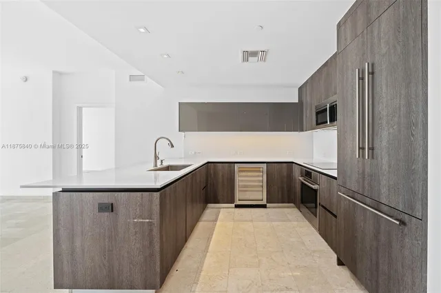 a kitchen with a refrigerator and a sink