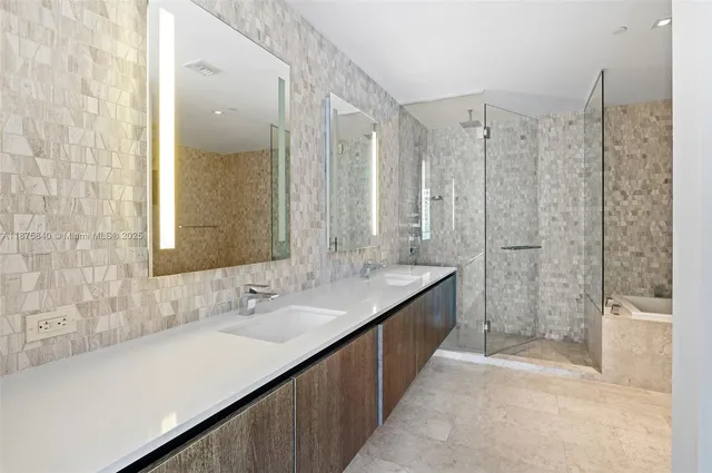 a bathroom with a tub a toilet and a sink