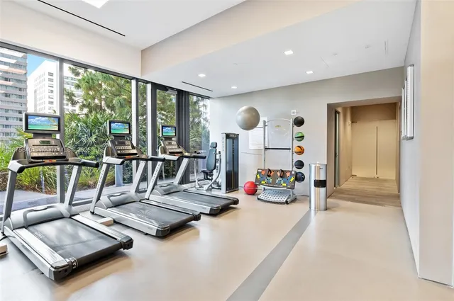 a view of a workspace with furniture and gym equipment