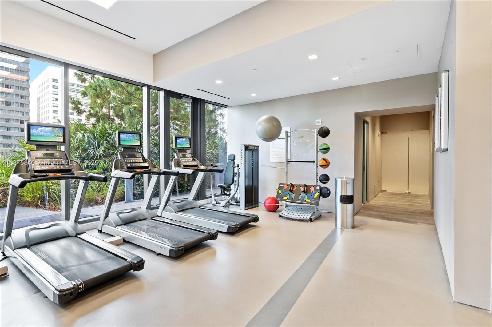 88 Southwest 7th Street, Unit 1403 Miami, FL 33130 - Photo 42 of 53 a view of a room with gym equipment